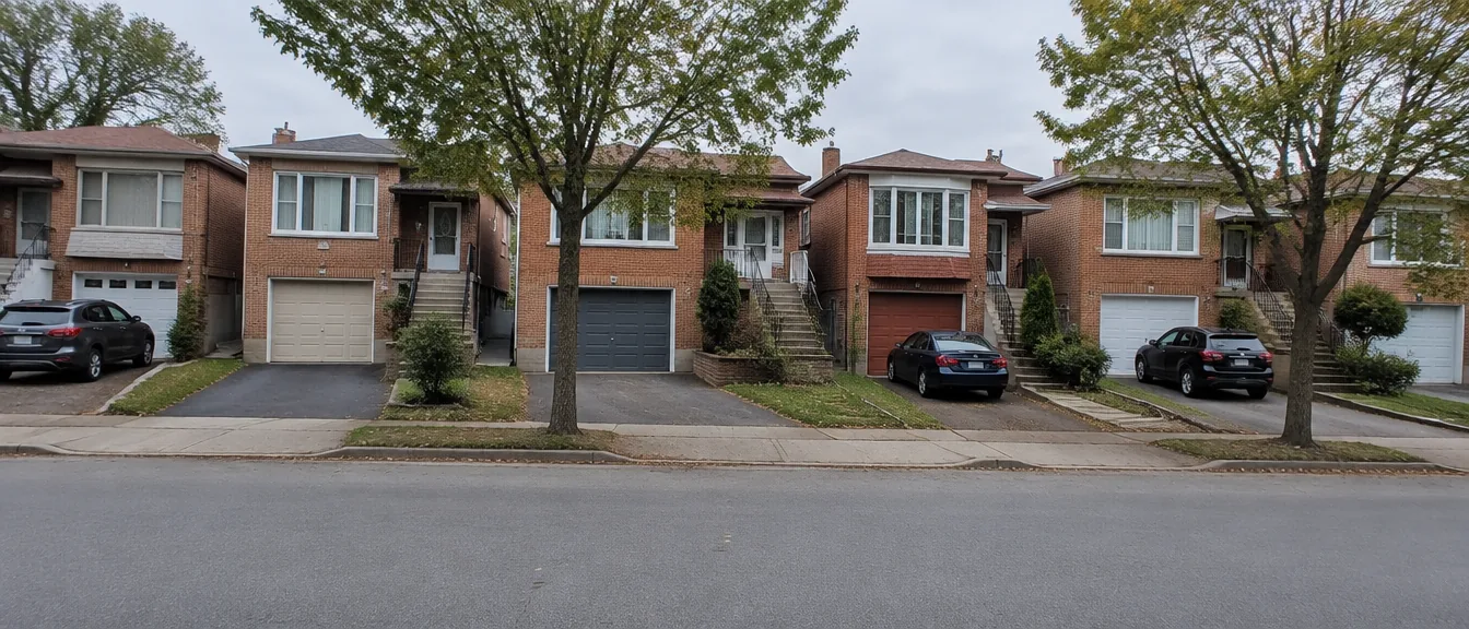 Row of houses with attached single-car garages on a residential street
